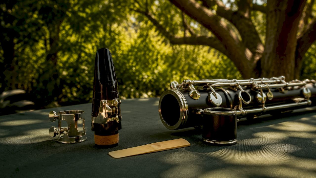 Disassembled bass clarinet parts on warm surface