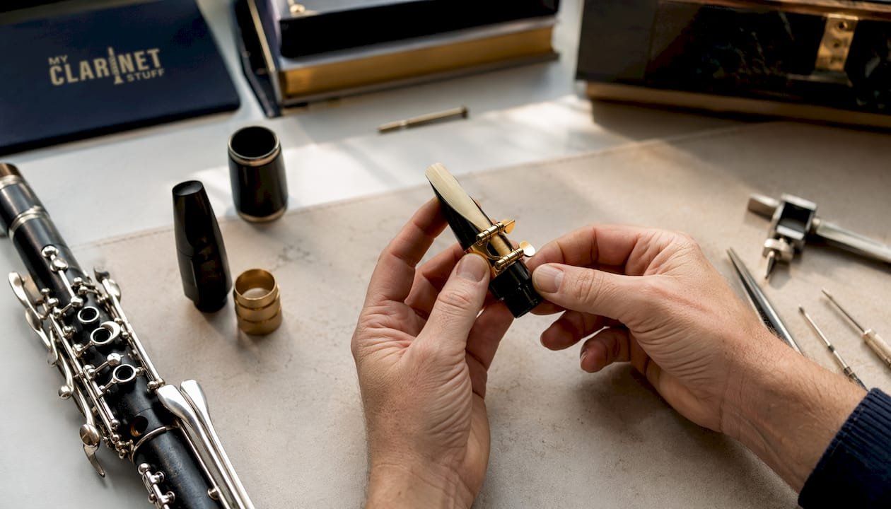 Teacher assembling clarinet mouthpiece with reed and ligature