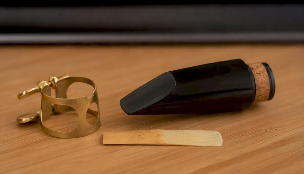 Clarinet mouthpiece and reed on wood surface